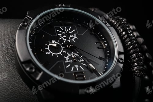 Preview: Closeup shot of a men's elegant wristwatch and bracelets