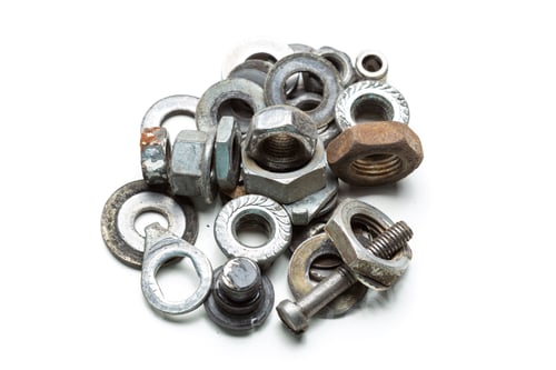 Preview: Various types of metal fasteners arranged in a mixed pile on a white surface