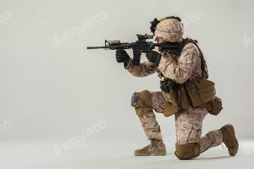 Preview: Military soldier in tactical gear preparing for action in a studio setting