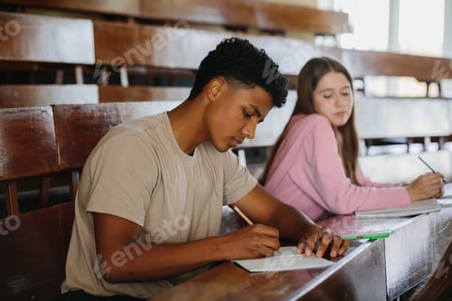 Preview: Focused Students Studying in a Classroom, Writing Notes During a Lesson