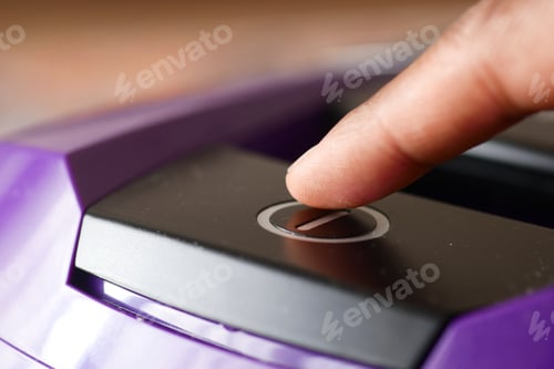 Preview: pressing start button on vacuum cleaner.
