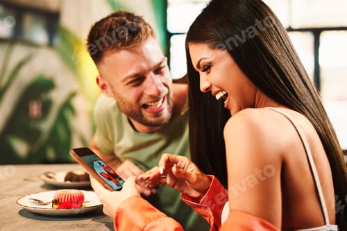 Preview: Young women using smartphone to take a photo of cake