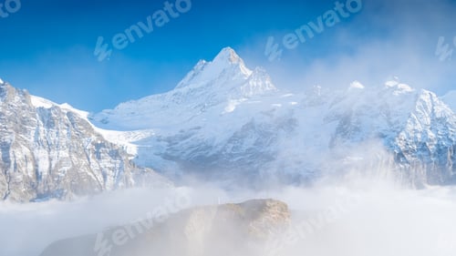 Preview: Nature. High mountain peaks above the clouds. Low clouds in the mountain valley.