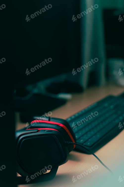 Preview: Music headphones and a computer keyboard on a desk
