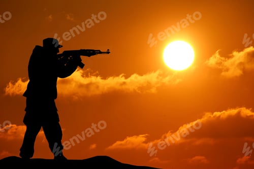 Preview: Silhouette shot of soldier holding gun with colorful sky and mountain in background