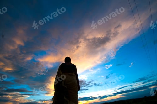 Preview: Silhouette of woman enjoying freedom at sunset.