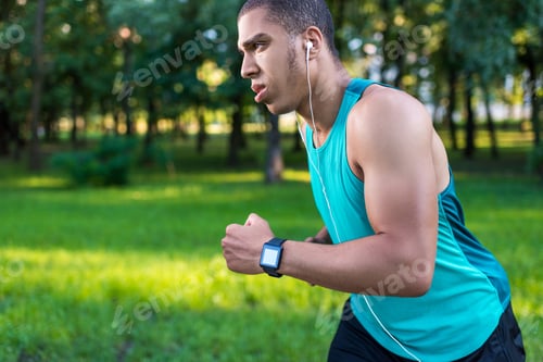 Preview: side view of handsome young african american sportsman running in park