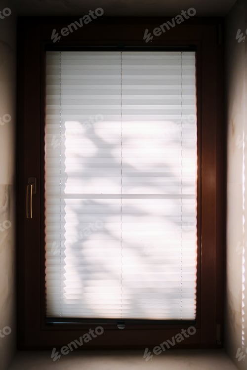 Preview: Sun glare on a pleated white curtain.
