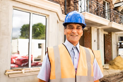 Preview: Portrait of confident indian male construction worker at construction site