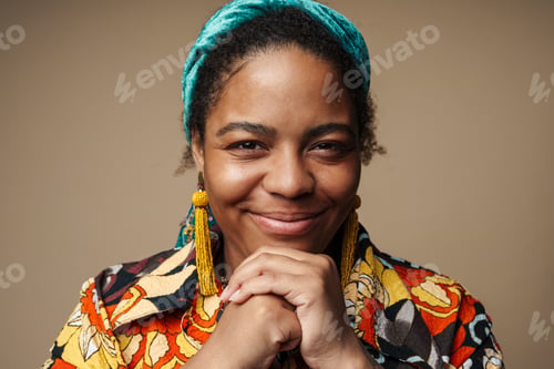 Preview: Young black woman in headband smiling and looking at camera