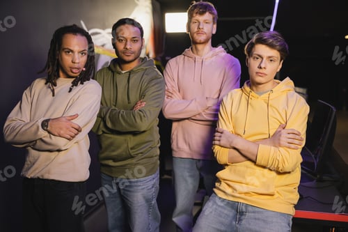 Preview: Multiethnic friends crossing arms looking at camera in cyber club