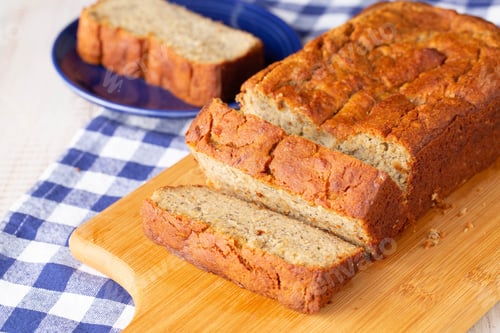Preview: Loaf Of Gluten Free Banana Bread With Slice On Blue Plate