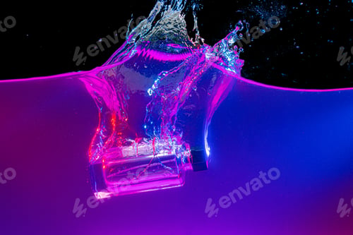 Preview: Perfume bottle diving into the water with a splash in neon light