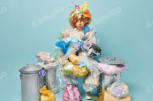 Preview: Indoor shot of displeased curly woman tired of collecting rubbish tries to stop plastic pollution lo