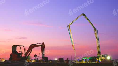 Preview: Workers group with concrete pump truck pouring concrete floor in construction site with sunset sky