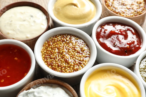Preview: Set of different delicious sauces as background, closeup