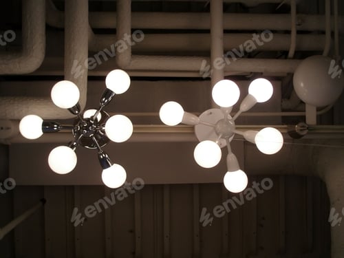 Preview: Looking up to lights suspended from the ceiling.