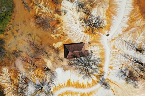 Preview: Aerial view of sinking village house in the middle of toxic mine decanting lake
