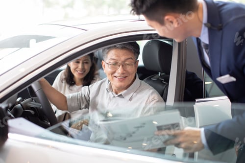 Preview: Happy mature Chinese couple taking a test drive