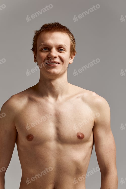 Preview: Young swimmer in excellent physical shape, on a gray background with copy space, call for sports