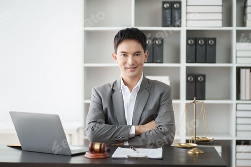 Preview: Young smart Asian lawyer working in his office room with laptop computer. Law firm concept.
