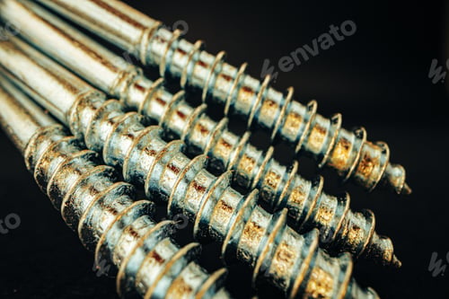 Preview: Many metal screws on concrete close up