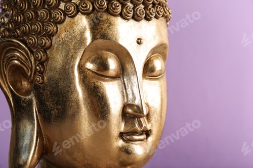 Preview: Beautiful golden Buddha sculpture on violet background, closeup. Space for text