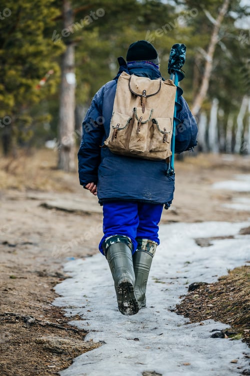 Preview: man fisherman goes through woods