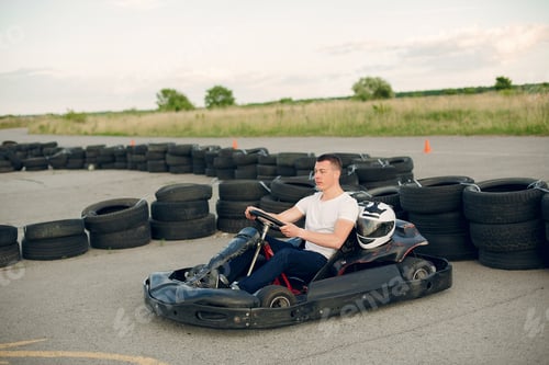 Preview: Handsome man in a karting with a car