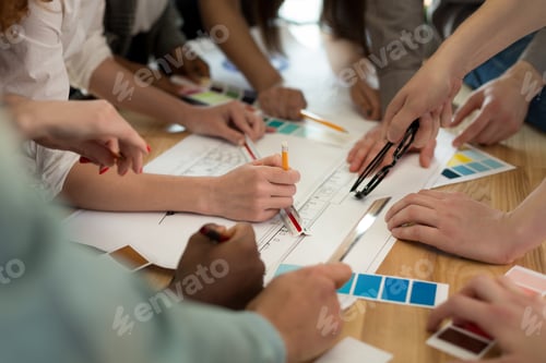 Preview: Team of architects working on construction plans