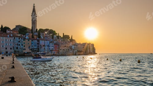 Preview: Golden sunset over the tranquil waters of Rovinj, Croatia, with boats dotting the harbor
