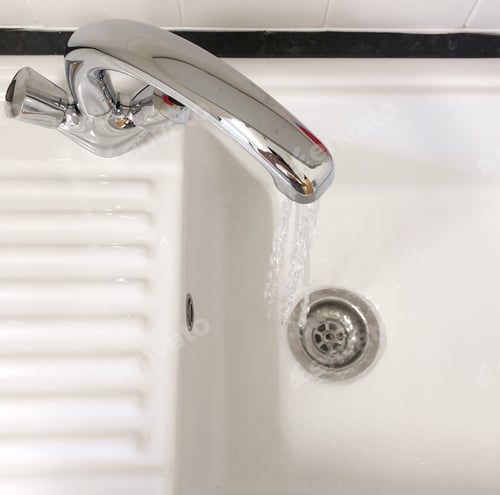 Preview: Running water from a silver tap facet into a white sink