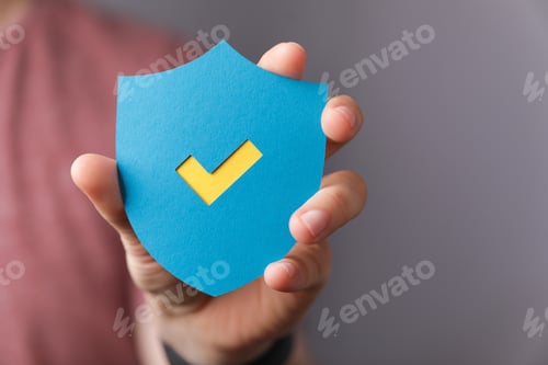 Preview: Sign of the checkmark made of paper in the hands of a man