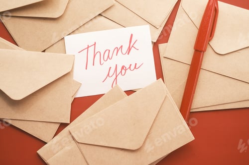 Preview: thank you message and envelope on wooden table