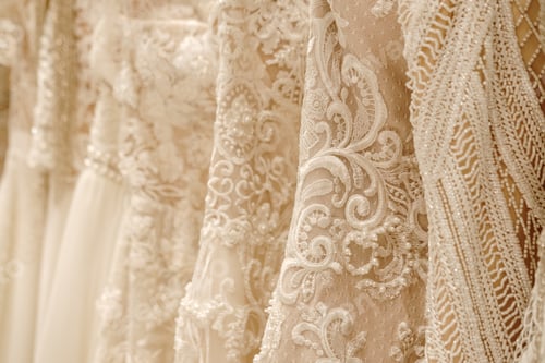 Preview: Cream wedding dresses hanging on the hanger. Bridal fashion concept
