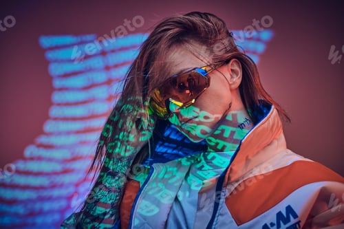 Preview: Close up portrait of a young tattooed racer woman posing in a vivid neon studio over text projection