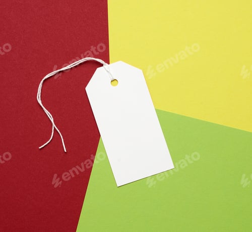Preview: White paper rectangular tag on a rope on a colored background, flat lay