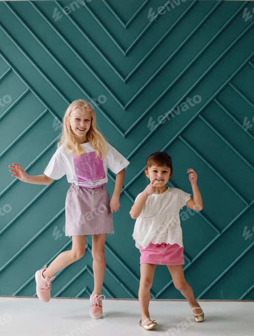 Preview: Childhood, fun, family concept. Fashionable sisters posing.