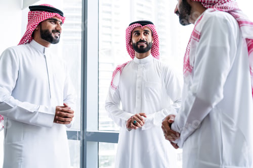Preview: Arab businessmen wearing saudi kandura meeting in office for business deal