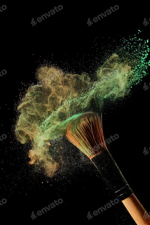 Preview: cosmetic brush with green and orange powder on black background