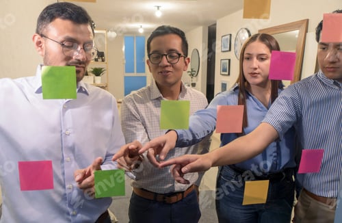 Preview: Group Of People Standing Around A Glass Wall With Sticky Notes On Them