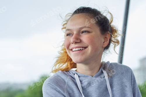 Preview: Closeup portrait of teenage girl of 14, 15 years old in gray sweatshirt