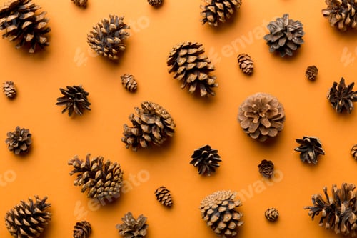 Preview: pine cones on colored table. natural holiday background with pinecones grouped together