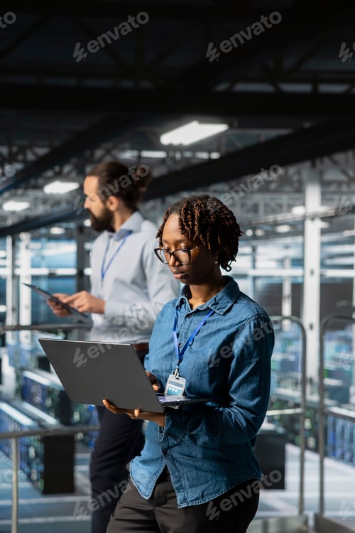 Preview: Data center programmer on industrial platform checking lines of code