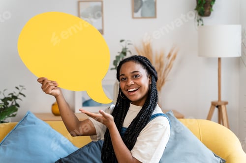 Preview: African american woman holding yellow text cloud.