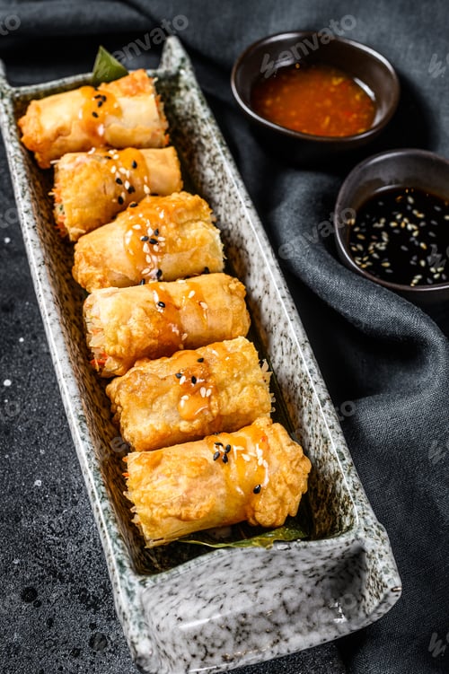 Preview: Fried spring rolls. Black background. Traditional Chinese cuisine. Top view