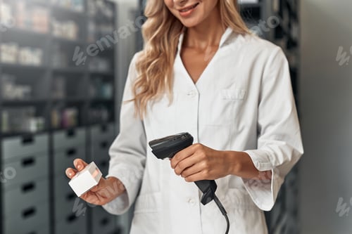 Preview: Scanning barcode on a medicine package at pharmacy counter