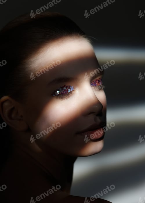 Preview: Portrait of woman with stripes of light on her face.