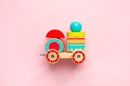 Preview: Wooden toy car with colorful blocks on pink background