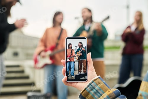 Preview: Young Caucasian Woman Photographing Multiethnic Musicians Performing Outdoors